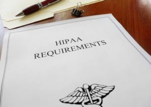 HIPAA healthcare requirements document with folder and pen