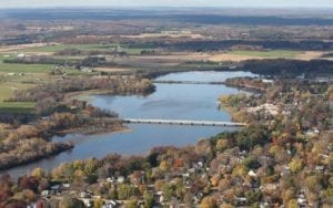 Overhead helicopter shot of Shawano county. Overlooking woods and a body of water